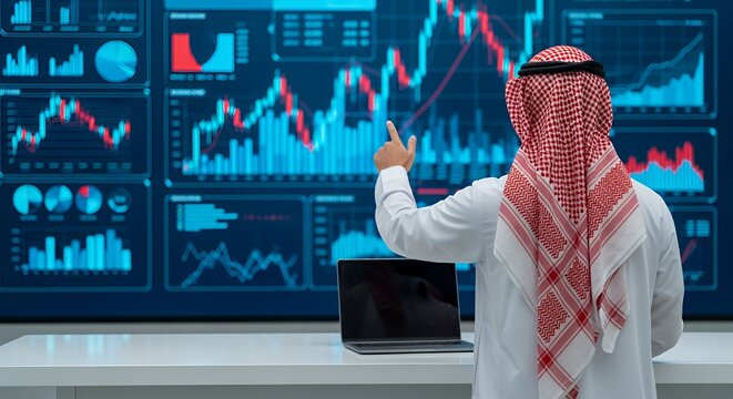 Arab Businessman Analyzing Financial Data on a Large Screen
