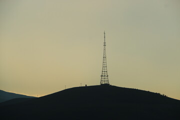 radio antenna silhouette over the mountain
