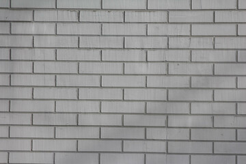 Gray brick wall texture showing uniform rectangular pattern in architectural detail