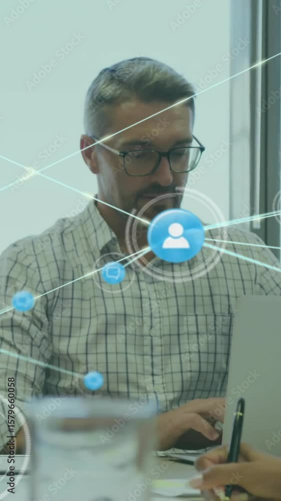 Poster animation of network of connections with icons over diverse colleagues using laptop in office