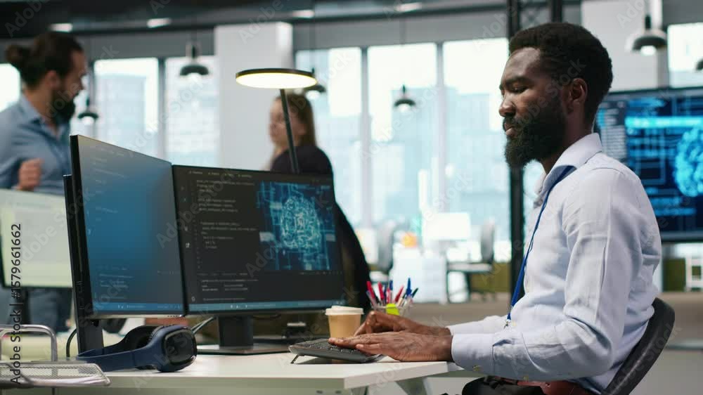 Poster System administrator in office using PC, automating repetitive tasks with AI scripts. IT specialist using artificial intelligence technology to speed up feature implementation, camera A