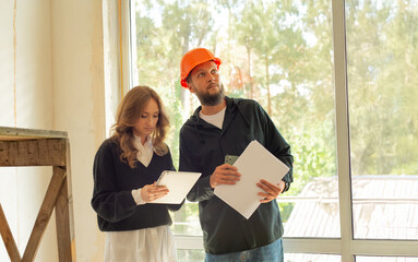 professional people at a house under construction being renovated.architect designer customer and...
