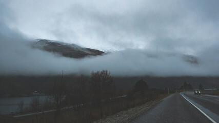 foggy landscape low cloud highway road grey cloudy overcast mountain hills new zealand