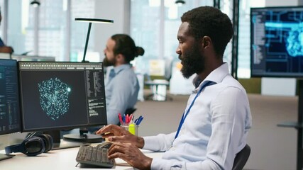 Software developer testing generative AI machine learning algorithms and listening music at work. African american man wearing headphones scaling productivity with AI large language model, camera A