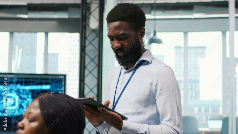 Poster technician next to office coworkers developing software applications, integrating artificial intelli