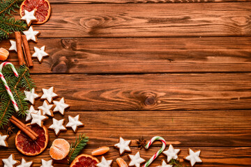 Composition with delicious stars shaped Christmas cookies, orange dried pieces, mandarin and fir...