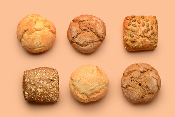 Different delicious buns on beige background