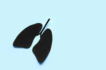 Black paper lungs on blue background
