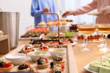 People with different appetizers at buffet, selective focus