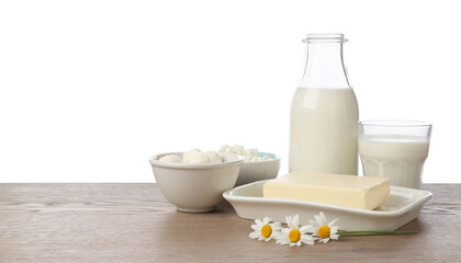 Different fresh dairy products and chamomile flowers on wooden table against white background