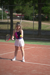 Beautiful Young woman playing tennis and possing outdoors, no edit image