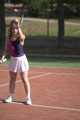 Beautiful Young woman playing tennis and possing outdoors, no edit image