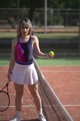 Beautiful Young woman playing tennis and possing outdoors, no edit image
