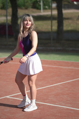 Beautiful Young woman playing tennis and possing outdoors, no edit image