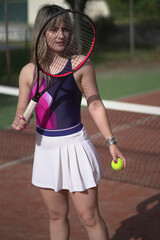 Beautiful Young woman playing tennis and possing outdoors, no edit image