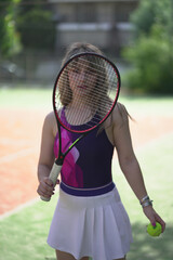 Beautiful Young woman playing tennis and possing outdoors, no edit image