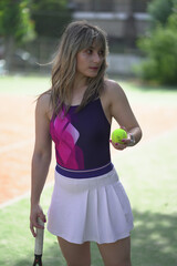 Beautiful Young woman playing tennis and possing outdoors, no edit image