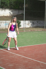 Obraz premium beautiful young woman playing tennis and possing outdoors, no edited image