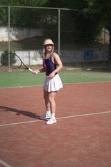 beautiful young woman playing tennis and possing outdoors, no edited image