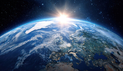 Obraz premium Sunrise over the Earth showing continents and starry sky