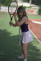 beautiful young woman playing tennis and possing outdoors, no edited image