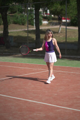 beautiful young woman playing tennis and possing outdoors, no edited image