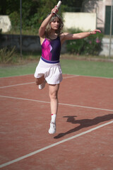 beautiful young woman playing tennis and possing outdoors, no edited image