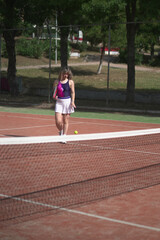 Obraz premium beautiful young woman playing tennis and possing outdoors, no edited image