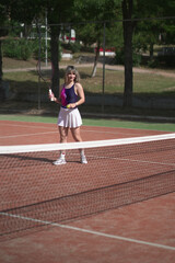 beautiful young woman playing tennis and possing outdoors, no edited image