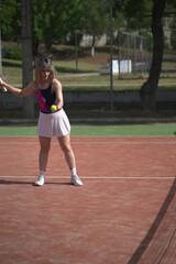 Fototapeta premium beautiful young woman playing tennis and possing outdoors, no edited image