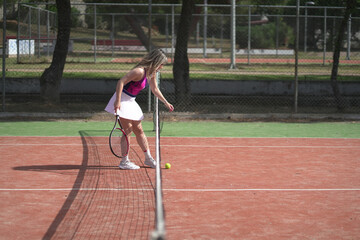 beautiful young woman playing tennis and possing outdoors, no edited image