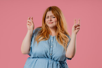  Attractive Body positive woman with hands fingers air quotes gesture on pink