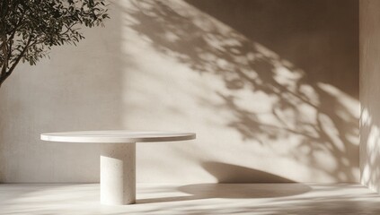 Minimalist, beige room with round, light-colored table and dappled sunlight
