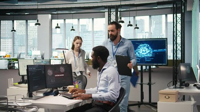 Programmer requests help from team leader to fix hacking attempt on corporate network. IT employee and manager investigating unauthorized access alerts, doing brainstorming, camera A