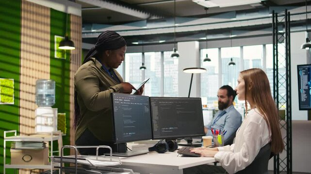 Friendly coworkers helping junior dev code AI algorithms to debug software issues and improve systems, teamwork concept. Welcoming team assisting newcomer in tech startup office, camera A