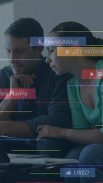 A young couple is talking and paying their bills using a laptop