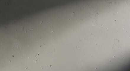 A textured off-white wall surface shows subtle light and shadow variations.