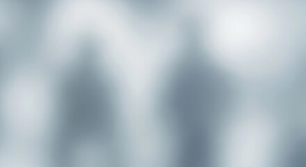 Blurred silhouettes of two figures against a soft, light-filled background.