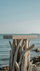 Unique wooden podium crafted from driftwood by the seaside with clear blue sky.