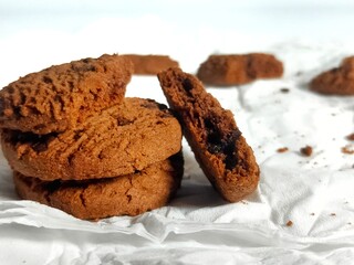 Chocolate Cookies on White Paper with Crumbs