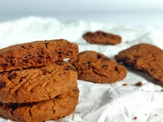 Chocolate Cookies on White Paper with Crumbs