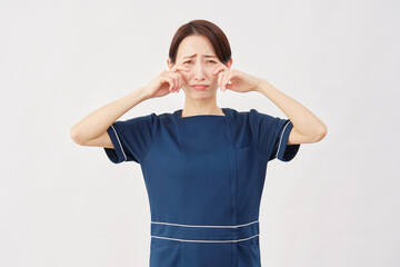 女性　美容看護師　泣く　白背景