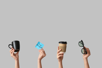 Female hands with coffee cups and eyeglasses on grey background. Time management concept