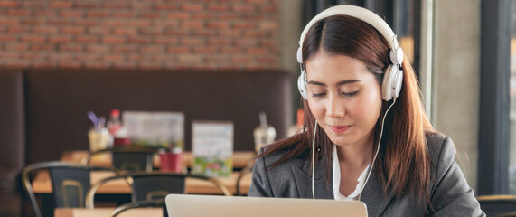 Banner Women helpdesk call center use headphones talk to customer. Asian woman customer service...