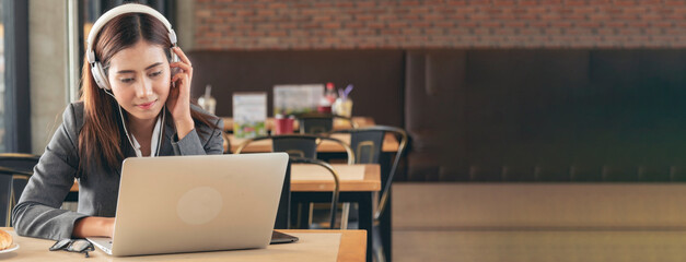 Banner Women helpdesk call center use headphones talk to customer. Asian woman customer service relationship agent. Businesswoman use laptop computer video call online meeting with copy space