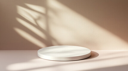 White round podium with soft shadows on beige background in warm light