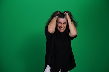 Unedited Portrait of Woman’s Face Expressing Various Emotions – Green Studio Background