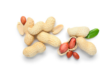 Many unpeeled and peeled peanuts with leaf on white background