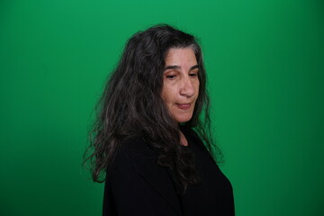 Fototapeta premium Unedited Portrait of Woman’s Face Expressing Various Emotions – Green Studio Background
