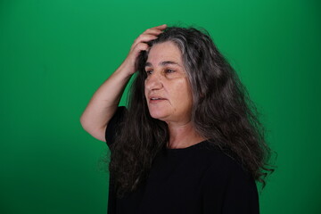 Unedited Portrait of Woman’s Face Expressing Various Emotions – Green Studio Background